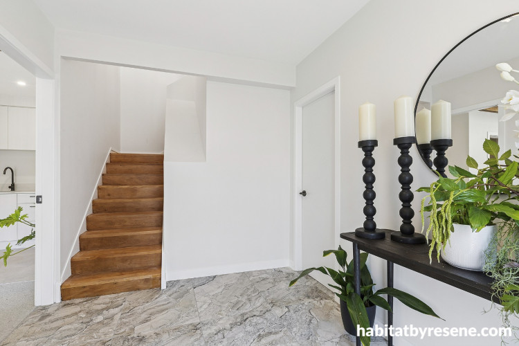 Entryway and stairwell painted in neutral white colours