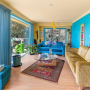 Living room featuring bright blue walls and pale yellow ceiling