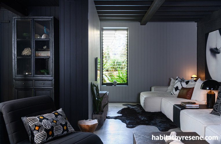 Living room featuring black and white walls