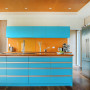 Ktichen featuring bold back wall and blue kitchen island