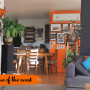 Living and dining area featuring bold orange and inky blue colours