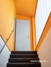 A stairwell painted in Resene Hero