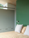 A bedroom with a green wall in Resene Ranger