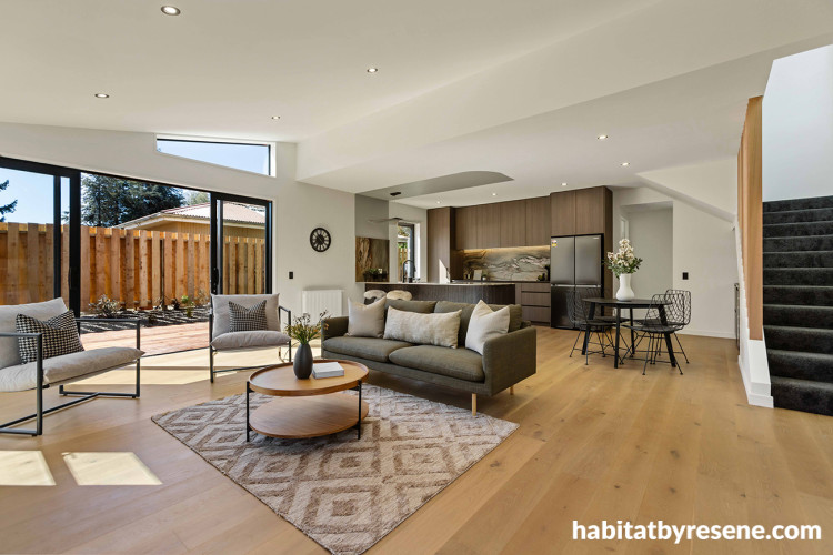 Living area and kitchen featuring neutral and earthy colours